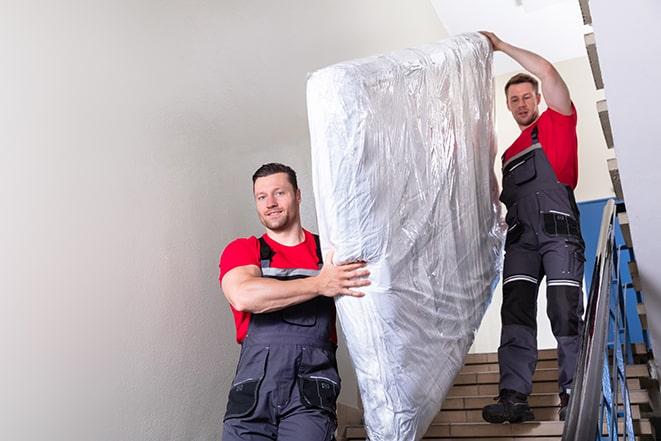 hauling away a worn-out box spring from a home in Elmwood Park